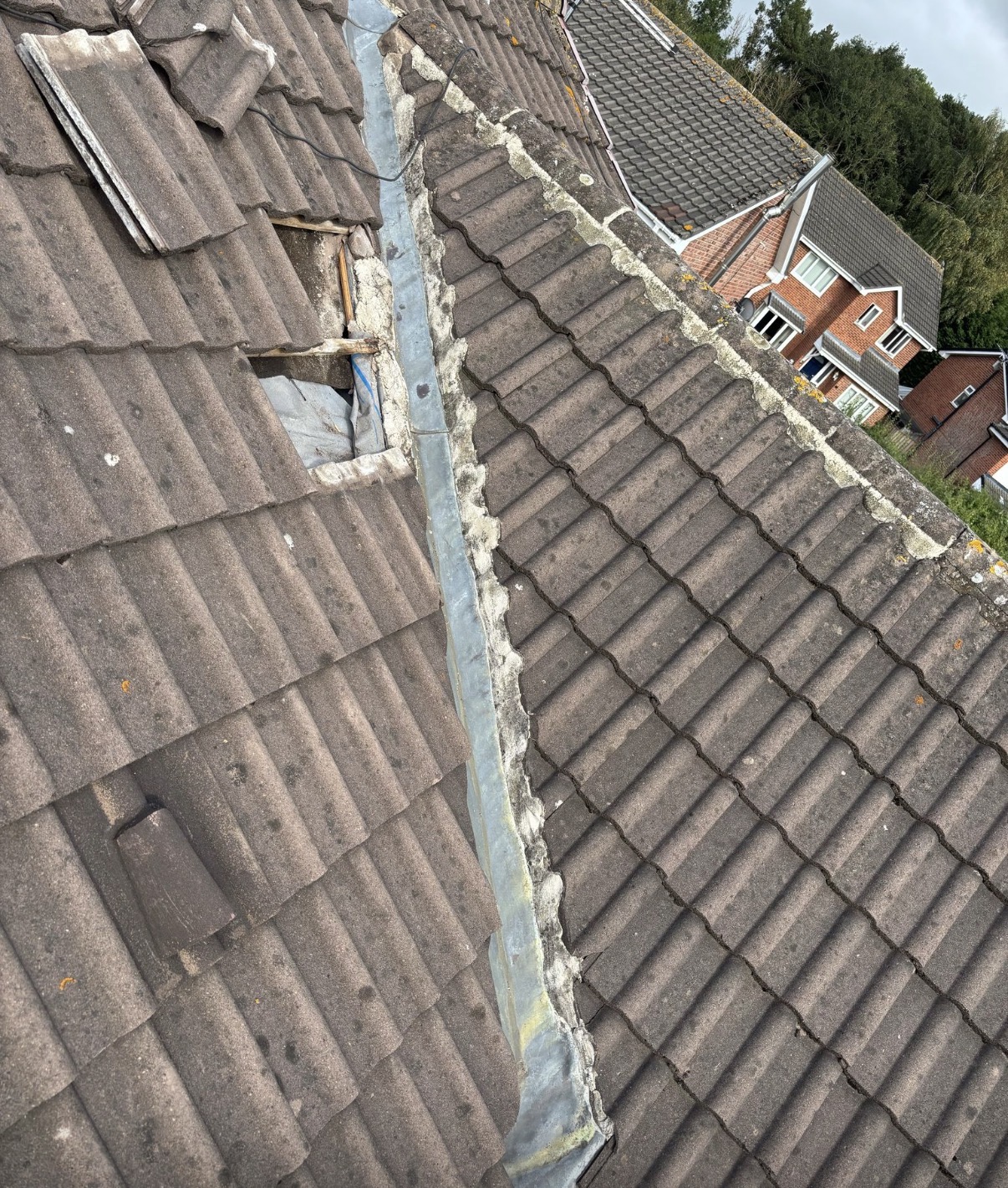 Repaired roof section with matched tiles